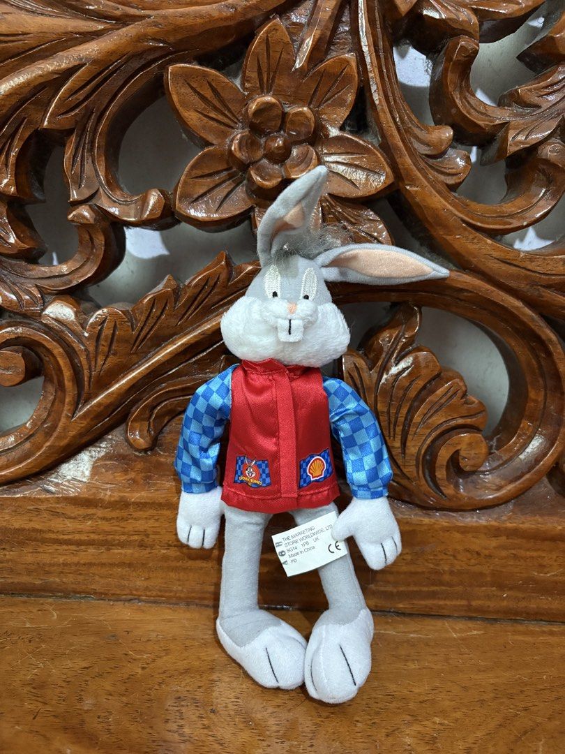Looney Tunes Bugs Bunny Shell Racing Plush 1999 (Category: Plushies & Soft Toys) located in Quezon City. Submitted by rxyel (Listing ID 1466167622, Image 1). Description: - Vintage 1999 Warner Bros. Bugs Bunny plush toy - Wears a red vest over blue checkered sleeves - Features rare Shell oil branding and trophy graphic - Original tush tag attached with copyright details - Clean fabric, ideal for collectors and fans.