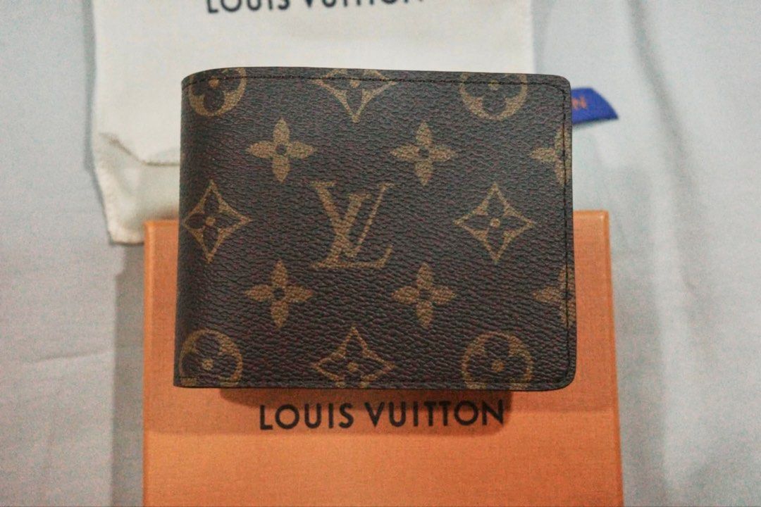 Louis Vuitton Monogram Canvas Bifold Wallet (Category: Luxury Bags & Wallets) located in Manila. Submitted by jdt1st (Listing ID 1466187976, Image 1). Description: - Authentic Louis Vuitton bifold wallet in classic brown monogram canvas - Condition: Brand New never used - Complete set: Includes original box, dust bag, blue ribbon, original paper bag and can show receipt bought in Paris, France - Carefully stored and well-maintained Louis Vuitton 