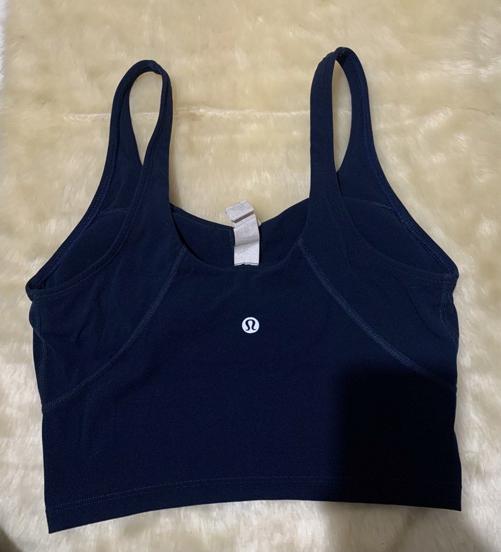 Lululemon Align Tank Navy Blue (Category: Activewear) located in Bayombong. Submitted by birkensaddiction (Listing ID 1466270156, Image 1). Description: - Brand: Lululemon - Color: Navy blue with white logo - Fit: Cropped scoop neck - Support: Built-in shelf bra with removable pads - Material: Comfortable, stretchy ribbed fabric - Condition: Brand new with tags Dot 4 Xs-Small.