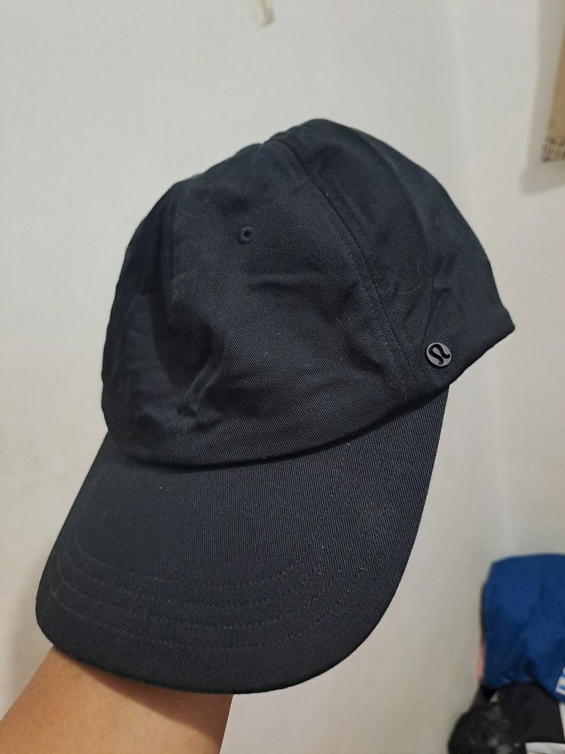Lululemon Black Adjustable Cap S (Category: Caps & Hats) located in Puerto Princesa. Submitted by jercksthriftph (Listing ID 1466330187, Image 1). Description: - Brand: Lululemon - Color: Black - Size: L/XL (Fits ~58cm head circumference) - Material: Cotton and nylon blend - Design: Classic curved brim, structured panels, adjustable strap back with branded metal slider - Condition: Clean, excellent overall condition with minimal wear inside and o