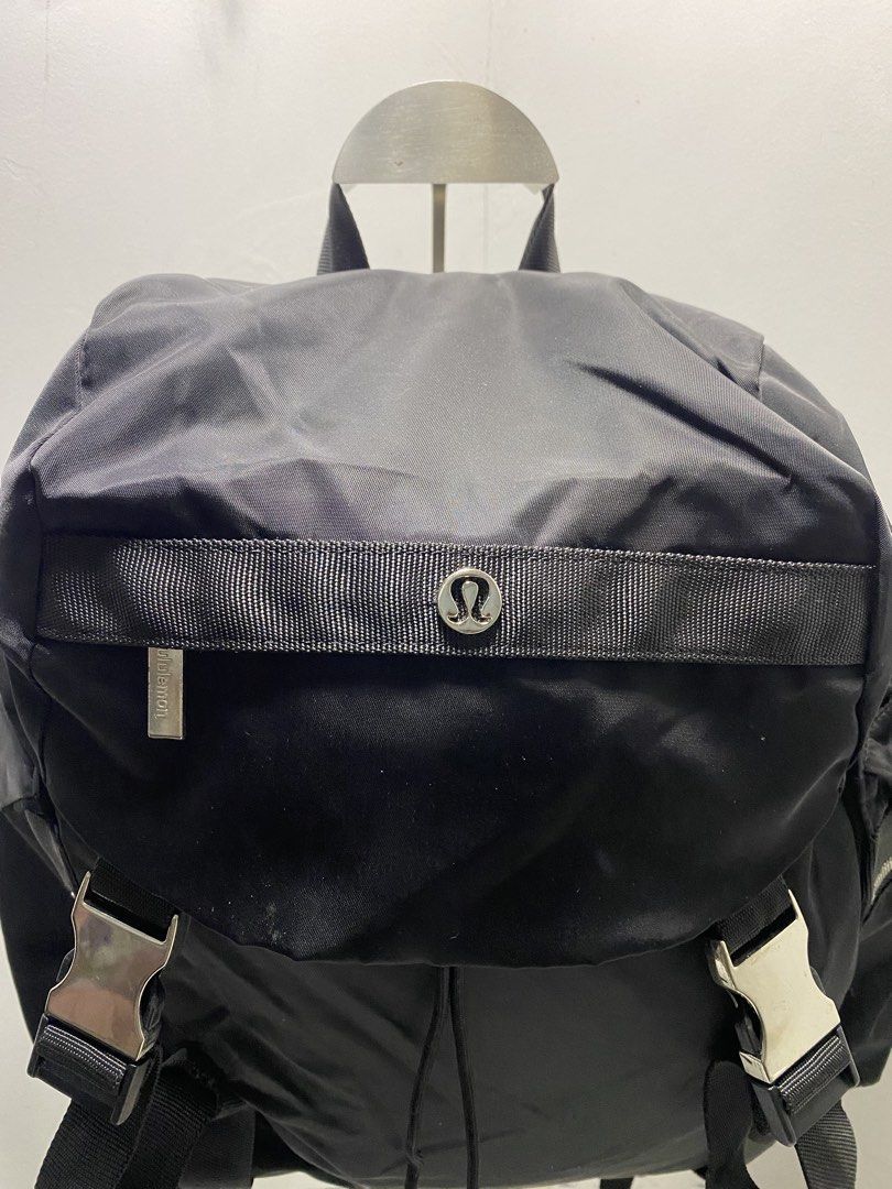 Lululemon Black Nylon Backpack (Category: Backpacks) located in Manila. Submitted by onfleekapparelph (Listing ID 1466168591, Image 2). Description: - Brand: Lululemon - Color: Classic Black - Material: Durable, water-resistant nylon - Closure: Drawstring main compartment with top flap and dual buckle locks - Pockets: Front and side zip pockets with branded metal hardware, plus an interior zip pocket - Comfort: Adjustable shoulder straps and stur
