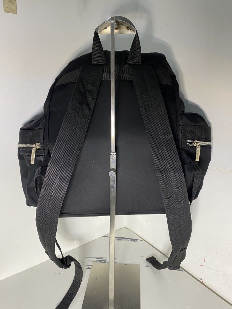 Lululemon Black Nylon Backpack (Category: Backpacks) located in Manila. Submitted by onfleekapparelph (Listing ID 1466168591, Image 3). Description: - Brand: Lululemon - Color: Classic Black - Material: Durable, water-resistant nylon - Closure: Drawstring main compartment with top flap and dual buckle locks - Pockets: Front and side zip pockets with branded metal hardware, plus an interior zip pocket - Comfort: Adjustable shoulder straps and stur