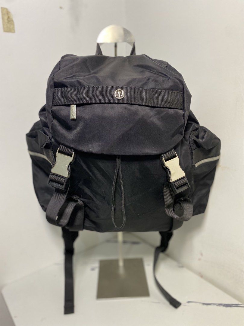 Lululemon Black Nylon Backpack (Category: Backpacks) located in Manila. Submitted by onfleekapparelph (Listing ID 1466168591, Image 1). Description: - Brand: Lululemon - Color: Classic Black - Material: Durable, water-resistant nylon - Closure: Drawstring main compartment with top flap and dual buckle locks - Pockets: Front and side zip pockets with branded metal hardware, plus an interior zip pocket - Comfort: Adjustable shoulder straps and stur