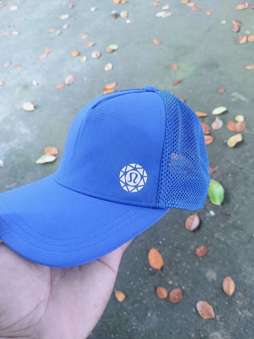 Lululemon Blue Mesh Trucker Cap Snapback Hat (Category: Activewear) located in Narra. Submitted by rhyanguan63087 (Listing ID 1466179859, Image 2). Description: - Authentic Lululemon hat in a vibrant bright blue color - Breathable mesh back panels to keep you cool during workouts - Adjustable snapback closure for a customizable fit - Iconic white Lululemon logo printed on the front - Made from a lightweight recycled polyester and elastane blend -