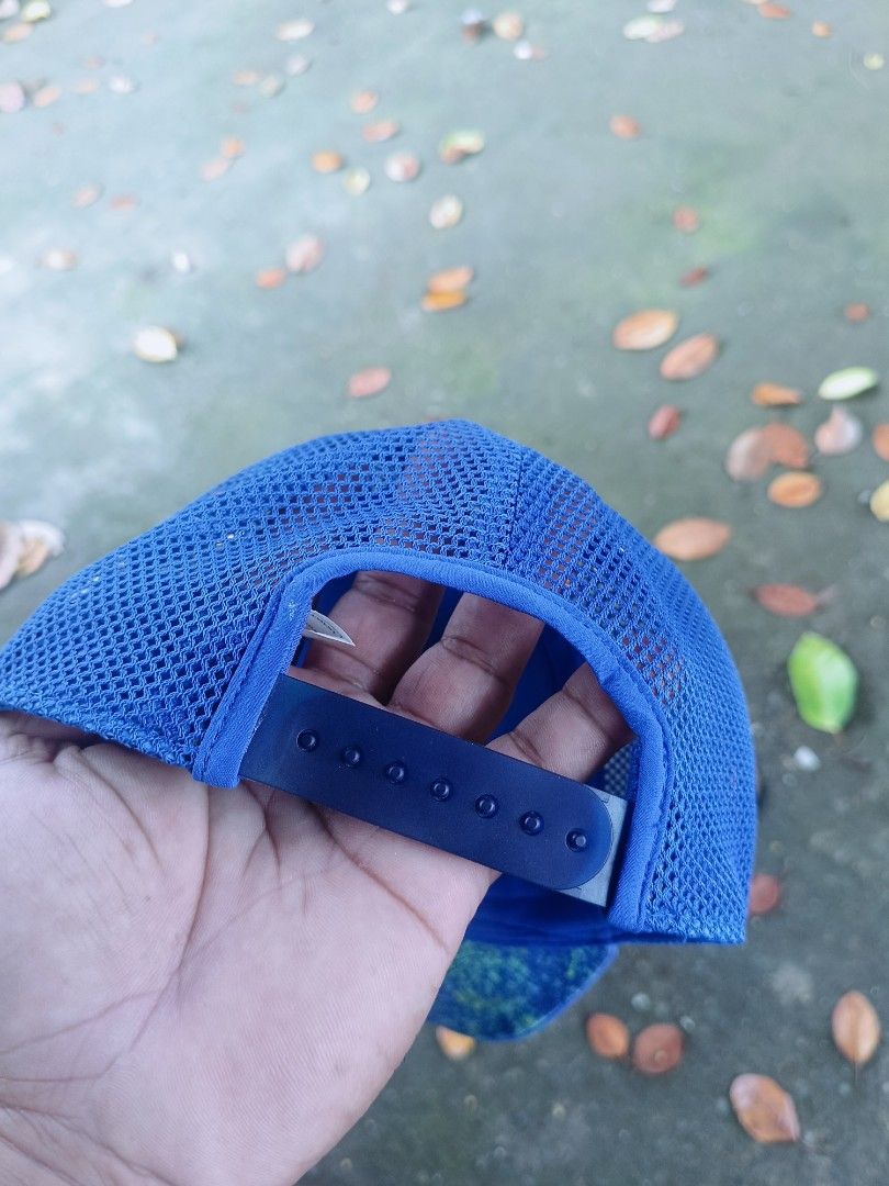 Lululemon Blue Mesh Trucker Cap Snapback Hat (Category: Activewear) located in Narra. Submitted by rhyanguan63087 (Listing ID 1466179859, Image 3). Description: - Authentic Lululemon hat in a vibrant bright blue color - Breathable mesh back panels to keep you cool during workouts - Adjustable snapback closure for a customizable fit - Iconic white Lululemon logo printed on the front - Made from a lightweight recycled polyester and elastane blend -