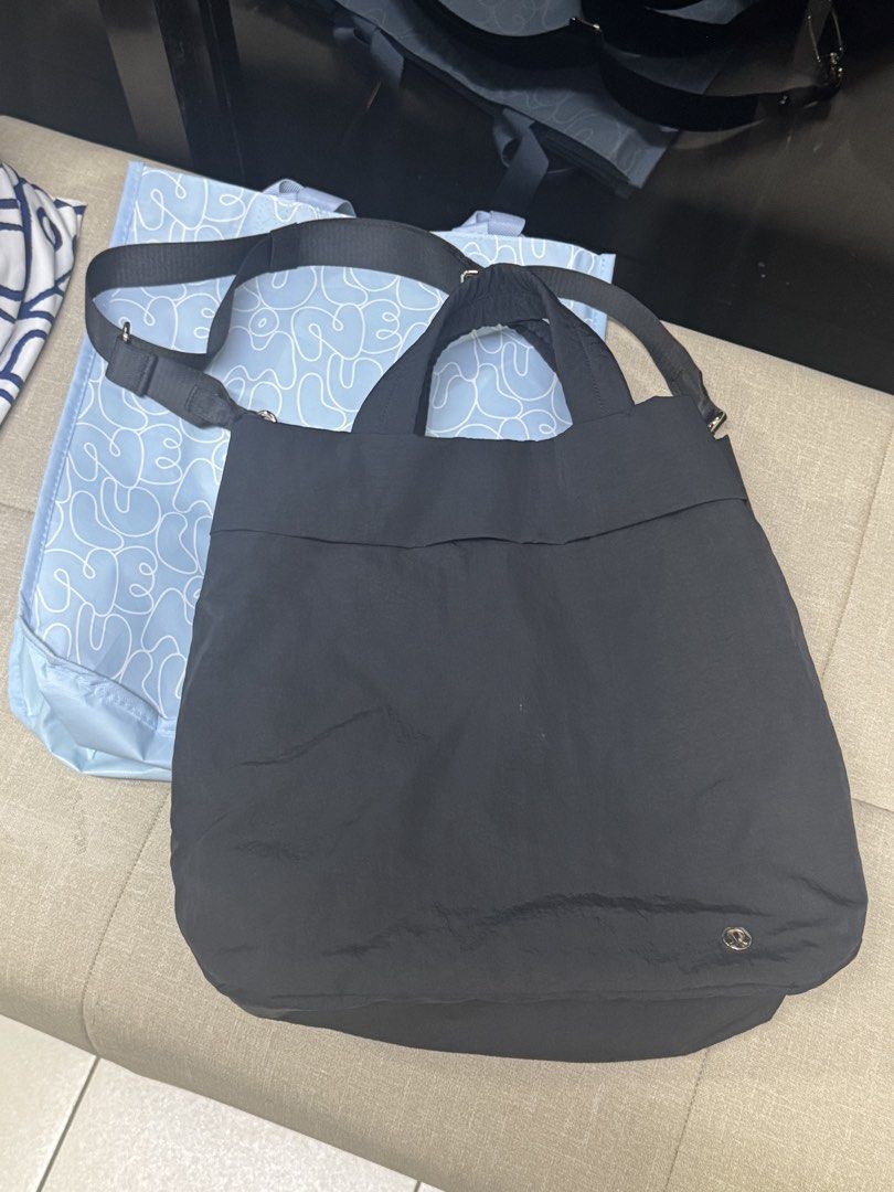 Lululemon On My Level Bag 2.0 19L (Category: Tote Bags) located in Calamba. Submitted by charmainegrace (Listing ID 1466162710, Image 1). Description: - Color: Black - Material: Soft unstructured nylon - Handles: Double top handles plus an adjustable crossbody strap - Features: Small metallic logo at the bottom right, roomy main compartment.