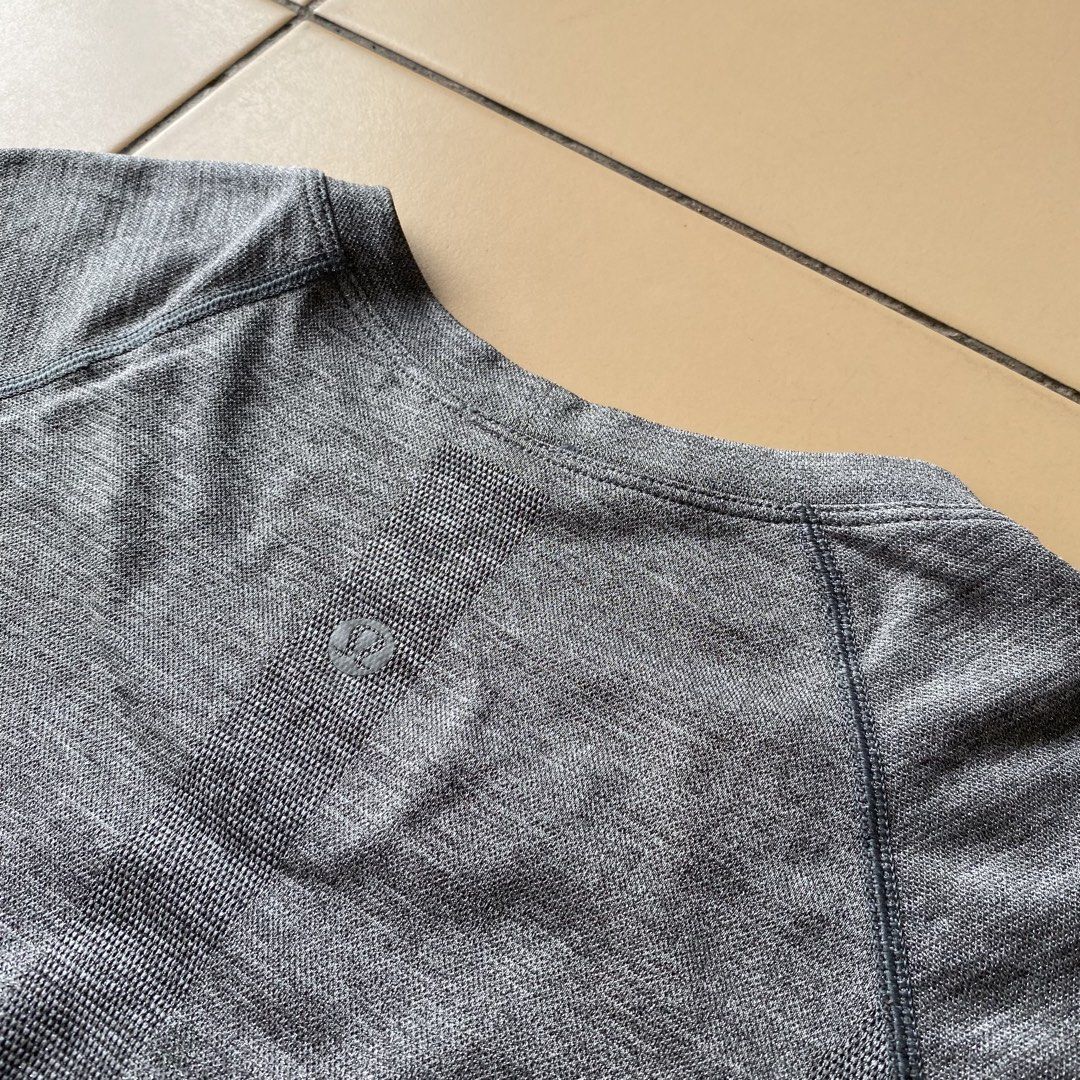 Lululemon Swiftly Tech Short Sleeve Crew Grey Size 6 (Category: Shirts) located in Bogo. Submitted by royalivio069630 (Listing ID 1466172662, Image 2). Description: Grey short sleeve athletic top from Lululemon. Size 6 printed inside the hem. Seamless knit fabric with textured detailing down the back and subtle motivational phrases printed near the bottom hem including 'BREATHE. REPEAT.' and 'MOVEMENT IS MEDICINE'. Classic crew neck style, great 