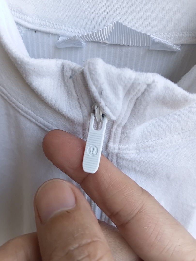 Lululemon White Ribbed Half Zip Hoodie Jacket (Category: Coats, Jackets and Outerwear) located in Manila. Submitted by grandflower-547aee (Listing ID 1466180423, Image 3). Description: - Brand: Lululemon - Color: Clean white - Style: Half-zip hoodie with high collar - Features: Ribbed back panel, extra-long ribbed cuffs with thumbholes, signature logo silver zipper pull, and small heat-pressed logo on lower back hem - Material: Soft and comfortab