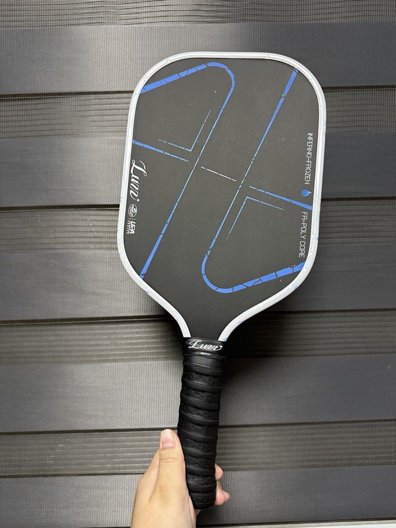 Luzz Inferno-Frozen FR-Poly Core Pickleball Paddle (Category: Racket and Ball Sports) located in Manila. Submitted by coleengui78044 (Listing ID 1466303471, Image 1). Description: - Brand/Model: Lunn Inferno-Frozen Paddle - Core: FR-Poly core for sturdy, competitive play - Design: Black hitting surface with blue geometric lines and white edge guard with 0°C Process branding - Handle: Wrapped black perforated grip with Lunn logo - Condition: Minim