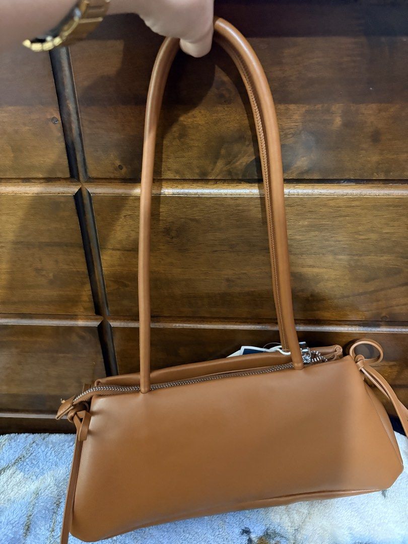 Madison West Brown Shoulder Bag (Category: Shoulder Bags) located in Subic. Submitted by aralleiah (Listing ID 1466181917, Image 2). Description: - Brand: Madison West Los Angeles - Color/Material: Brown faux leather - Condition: Brand new with Marshalls store tag attached (Compare at $40) - Closure: Top zipper and magnetic snap compartment - Straps: Slim double straps for comfortable shoulder wear - Interior: Lined with a convenient zippered sid