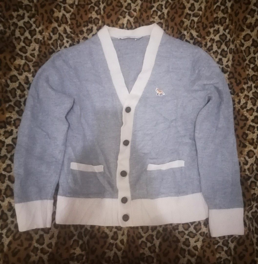 Maison Kitsune Paris Grey Wool Cardigan (Category: Coats, Jackets and Outerwear) located in Cebu City. Submitted by roadthrift (Listing ID 1466163018, Image 1). Description: Maison Kitsuné Paris grey wool cardigan. Size S. Contrast white button placket, cuffs, and hem. Button-down front with two front pockets. Embroidered fox patch on the chest. Made from 100% wool. Hand wash only..