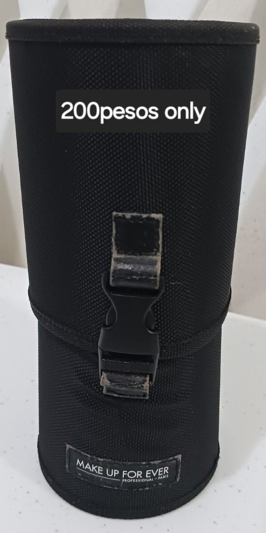 MAKE UP FOR EVER cylinder brush holder (Category: Makeup) located in Taguig. Submitted by l.a.8 (Listing ID 1466223758, Image 1). Description: - Authentic MAKE UP FOR EVER brush holder - Made of durable and sturdy black nylon material - Features a secure plastic buckle closure in the middle - Cleverly detaches into two separate cups for easy access - Compact and practical design, perfect for storing makeup brushes and tools -no return/exchange on