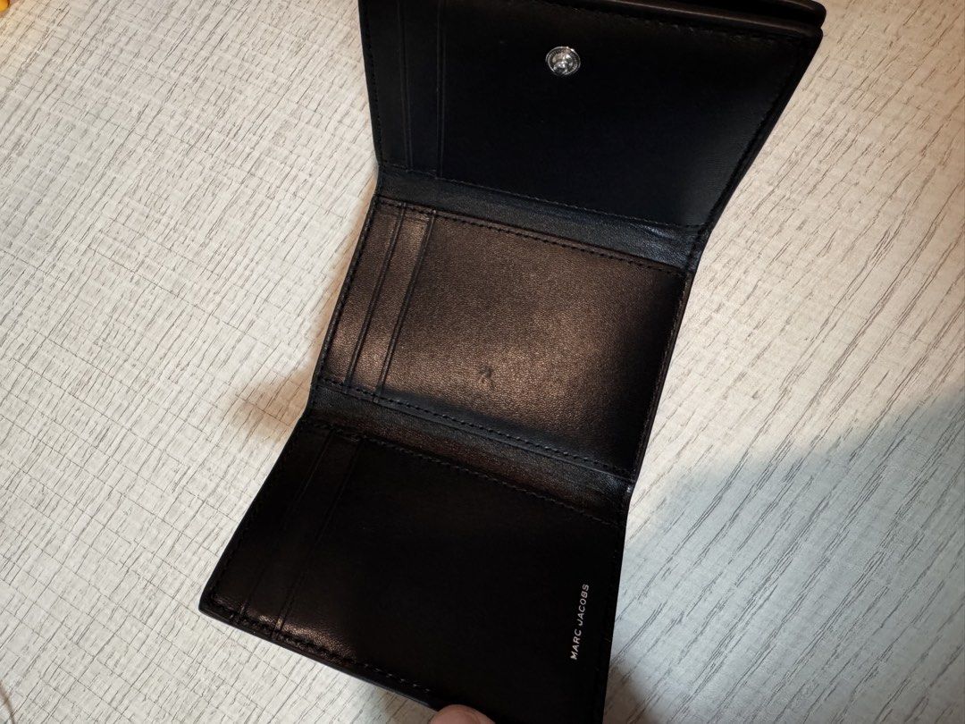 Marc Jacobs Black Leather Trifold Wallet (Category: Luxury Bags & Wallets) located in Paranaque City. Submitted by lersprelovedclothes (Listing ID 1466255103, Image 3). Description: - Authentic Marc Jacobs NYC 1984 trifold wallet - Premium black grained leather with silver foil logo lettering - Secure snap button closure - Multiple card slots and slip compartments - Compact size, perfect for small bags and pockets - Clean interior with subtle bra