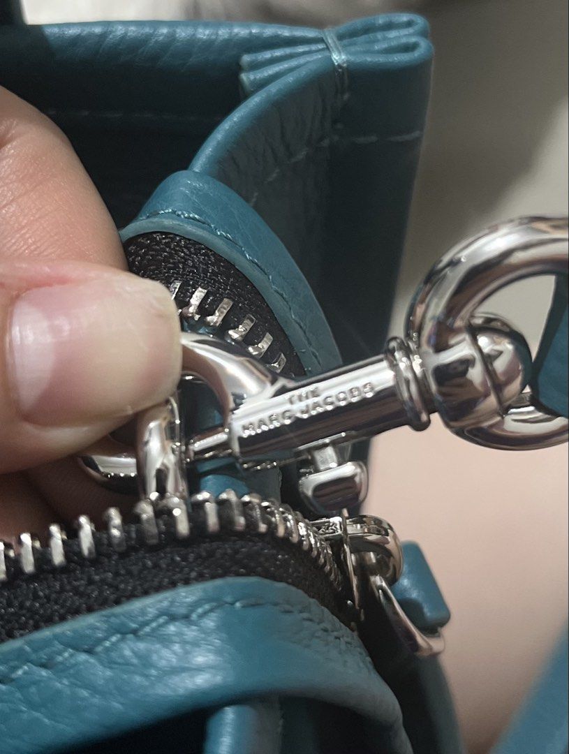 Authentic Marc Jacobs (Category: Luxury Bags & Wallets) located in Manila. Submitted by dominique_737 (Listing ID 1466311468, Image 3). Description: Marc Jacobs small leather tote bag in a vibrant teal color. Grainy leather texture, double top handles, detachable crossbody strap. Zipper top closure. Interior includes a slip pocket and branded fabric patch. Dust bag and tags included in the main compartment. Hardware stamped with Marc Jacobs lette