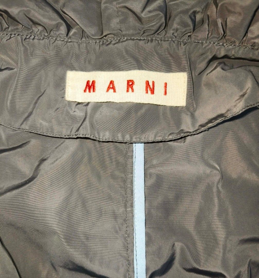 Marni Ruffled Collar Lightweight Jacket (Category: Coats, Jackets and Outerwear) located in Baguio. Submitted by luxeloom099 (Listing ID 1466172988, Image 2). Description: Brand: Marni ​Description: Elevate your outerwear with this designer Marni Ruffled Collar Lightweight Jacket made in Italy. Crafted from a cotton-nylon blend, it features statement ruffle trim around the oversized collar and front button placket, plaid/striped trim accents alon