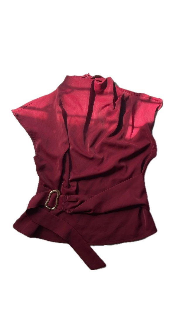 Maroon High Neck elegant sleeveless top (Category: Blouses) located in La Trinidad. Submitted by ezraaaa29 (Listing ID 1466165725, Image 1). Description: - Color: Rich maroon - Style: Sleeveless top with an elegant high neckline - Design: Smooth, flowing drape at the front with a back zipper closure - Accessory: Includes a matching waist belt with a chic gold-tone buckle - Occasion: Versatile piece ideal for office wear or dinner outings.