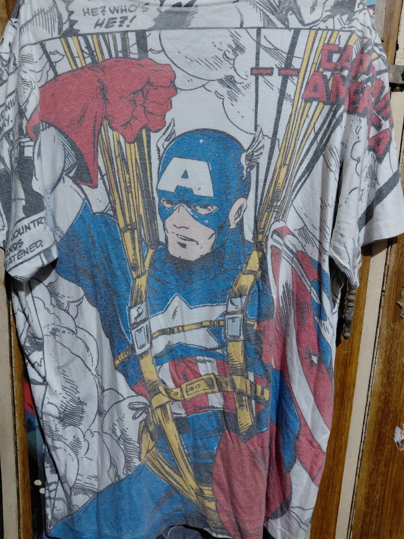 Marvel Captain America Graphic Comic Print T-shirt (Category: Tshirts & Polo Shirts ) located in Imus. Submitted by frootiloots4103 (Listing ID 1466314396, Image 2). Description: - Brand: Official Disney Marvel Comics merchandise - Design: All-over Captain America comic book print in vibrant red, blue, and yellow on a white base - Fit & Size: Men's/Unisex Size M, short sleeves, crew neck - Details: Authentic Marvel Comics logo stitched on the sle