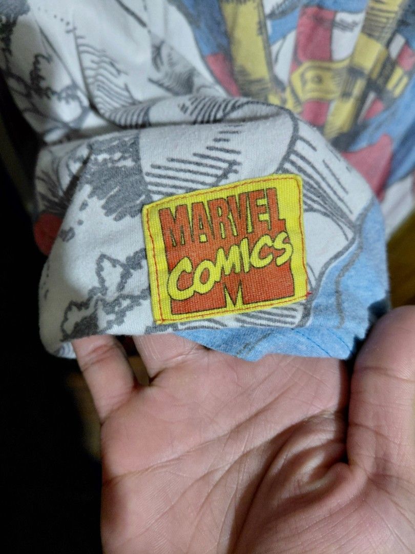 Marvel Captain America Graphic Comic Print T-shirt (Category: Tshirts & Polo Shirts ) located in Imus. Submitted by frootiloots4103 (Listing ID 1466314396, Image 3). Description: - Brand: Official Disney Marvel Comics merchandise - Design: All-over Captain America comic book print in vibrant red, blue, and yellow on a white base - Fit & Size: Men's/Unisex Size M, short sleeves, crew neck - Details: Authentic Marvel Comics logo stitched on the sle