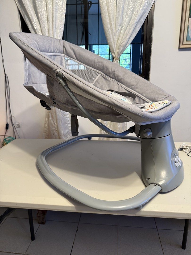 Mastela Baby Rocker (Category: Cots & Cribs) located in Rodriguez. Submitted by bmade08 (Listing ID 1466288106, Image 2). Description: Flaw: No longer functional with batteries. Need repair. Can still rock/swing manually - Brand: Mastela - Color: Grey with patterned seat pad - Safety: Built-in head support cushion and secure harness straps - Comfort: Breathable mesh sides for great airflow and visibility - Design: Sturdy plastic base with easy-to