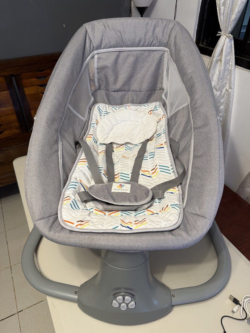 Mastela Baby Rocker (Category: Cots & Cribs) located in Rodriguez. Submitted by bmade08 (Listing ID 1466288106, Image 1). Description: Flaw: No longer functional with batteries. Need repair. Can still rock/swing manually - Brand: Mastela - Color: Grey with patterned seat pad - Safety: Built-in head support cushion and secure harness straps - Comfort: Breathable mesh sides for great airflow and visibility - Design: Sturdy plastic base with easy-to