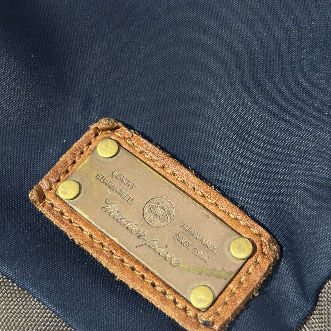 masterpiece / master-piece MSPC "CUBE" Shoulder Bag, a utilitarian messenger-style sling bag (Category: Sling Bags) located in Magalang. Submitted by luxgood18 (Listing ID 1466199964, Image 2). Description: • Brand: master-piece (MSPC) — A renowned high-end Japanese bag brand known for marrying premium materials with urban functional wear. • Model: CUBE Series (Model No. 02772). • Design Features: The bag is constructed from highly durable navy n
