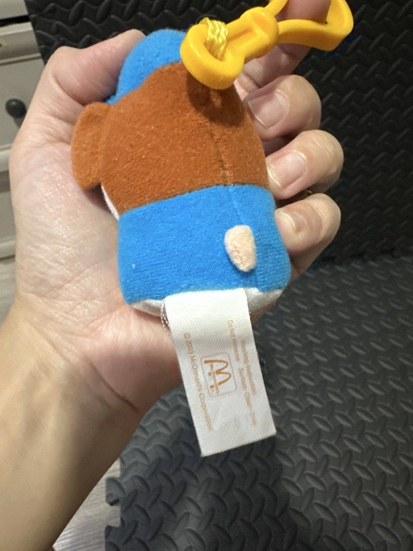 McDonald's Hamtaro Plush Keychain 2003 (Category: Character Goods) located in Cainta. Submitted by shopbyyna (Listing ID 1466264741, Image 2). Description: - Rare 2003 McDonald's Hamtaro plush keychain - Wears an adorable blue cap and blue shirt with the iconic yellow McDonald's M logo - Comes with a sturdy yellow plastic clip at the top for easy hanging - Features original white tag on the back with McDonald's copyright text and logo - Made with