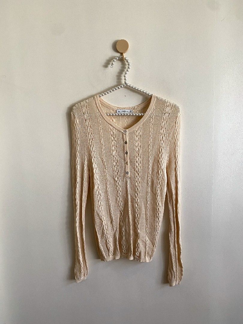 Medium - Zara Open Knit Cardigan (Category: Others Tops) located in Castillejos. Submitted by lalainecloset22 (Listing ID 1466180056, Image 2). Description: - Brand: Zara - Size: Medium (EUR M / USA M) - Color: Soft Cream / Nude Peach - Material: Breathable open-knit fabric with delicate cable knit patterns - Features: Round neckline, long sleeves, and dainty mother-of-pearl style front buttons - Condition: Excellent pre-loved condition - Perfect
