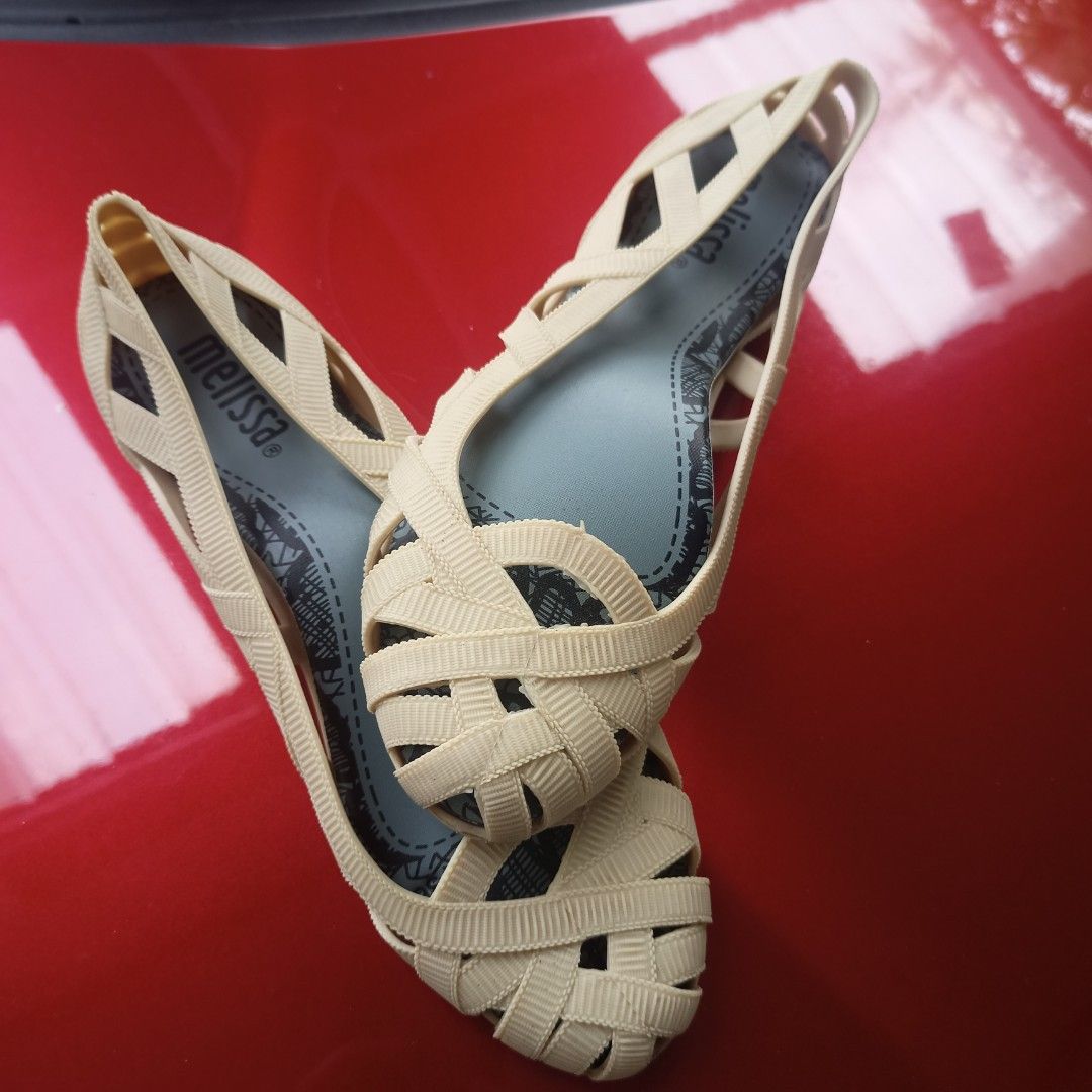 Melissa Cream Jelly Flats Size US 5 (Category: Flats & Sandals) located in Paranaque City. Submitted by jzet23 (Listing ID 1466203096, Image 3). Description: - Brand: Melissa - Style: Jelly flats with woven strap design and slip-on style - Color: Cream with cute lace-print insoles - Size: USA 5, EUR 36, JPN 22.5 - Condition: Pre-loved with significant cracking and damage on the bottom sole of one shoe - Perfect for casual days or beach trips at a