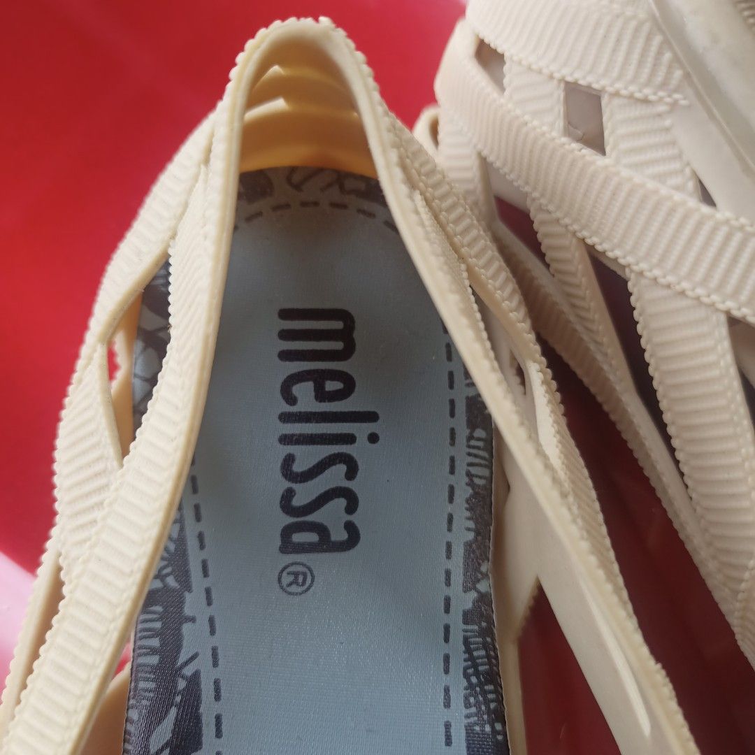 Melissa Cream Jelly Flats Size US 5 (Category: Flats & Sandals) located in Paranaque City. Submitted by jzet23 (Listing ID 1466203096, Image 2). Description: - Brand: Melissa - Style: Jelly flats with woven strap design and slip-on style - Color: Cream with cute lace-print insoles - Size: USA 5, EUR 36, JPN 22.5 - Condition: Pre-loved with significant cracking and damage on the bottom sole of one shoe - Perfect for casual days or beach trips at a