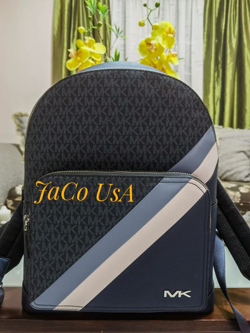 Michael Kors Cooper Logo and Striped Backpack (Category: Shoulder Bags) located in Taytay. Submitted by itsjacousa (Listing ID 1466294309, Image 1). Description: Color/Style: Chambray Navy/Blue with a bold white-and-navy racing stripe across the front zip pocket Dimensions: 12.5"W X 16.2"H X 6.5"D Exterior details: Front zip pocket Interior details: 2 Front slip pockets, laptop compartment.