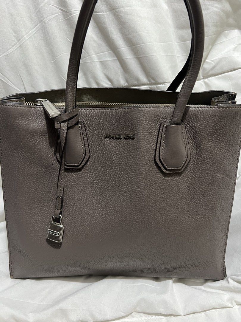 Michael Kors Mercer Medium Grey Leather Tote Bag (Category: Tote Bags) located in Pasig City. Submitted by madiesbags (Listing ID 1466328315, Image 1). Description: - Brand: Michael Kors - Material: Taupe grey pebble leather with silver hardware - Design: Structured base with metal feet and signature padlock charm - Interior: Fabric-lined with multiple compartments and a secure zippered pocket - Closure: Top zip closure for security - Condition: 