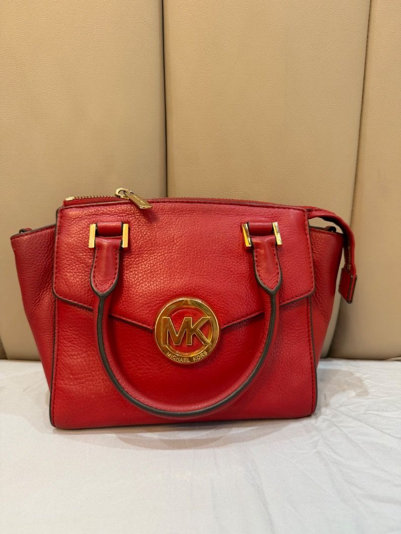 Michael Kors Red Leather Satchel Handbag (Category: Luxury Bags & Wallets) located in Caloocan City. Submitted by je_resada (Listing ID 1466308252, Image 2). Description: - Brand: Michael Kors - Color: Bright Red - Material: Genuine Leather - Hardware: Gold-tone with signature MK logo plaque - Features: Structured top handles, detachable shoulder strap, clean interior with pockets - Condition: Excellent - Mode of Payment: BPI / GCash - Shipping: 