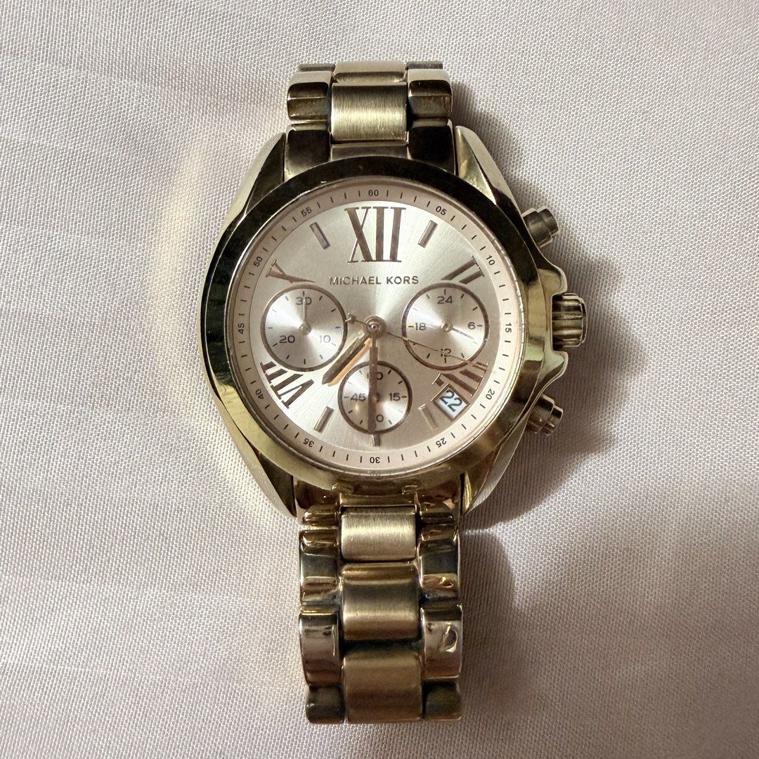 Michael Kors Rose Gold Watch (Category: Women's Watches) located in Manila. Submitted by she_alice (Listing ID 1466327464, Image 3). Description: - Brand: Michael Kors Authentic - Color/Finish: Rose gold tone stainless steel - Dial: Large round dial with Roman numerals, 3 sub-dials, and date display at 4 o'clock - Condition: Noticeable minor scratches on the bezel and bracelet, still in good condition but needs cleaning -Actual pics posted -Bough