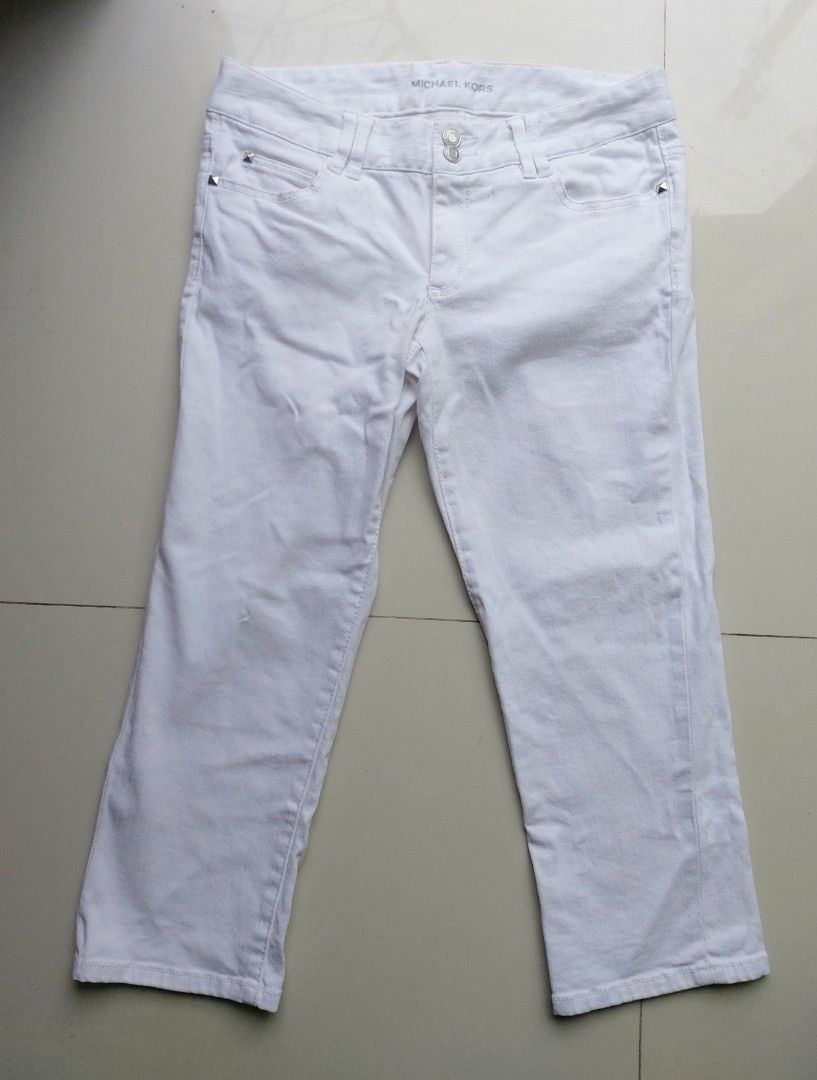 Michael Kors White Cropped Denim Jeans (Category: Jeans) located in Lapu Lapu. Submitted by agnesapm_29813 (Listing ID 1466282192, Image 1). Description: - Brand: Michael Kors - Color: Clean white wash - Fit: Mid-rise cut with standard belt loops - Closure: Unique double button waist - Details: Silver studded detailing on back pocket flaps - Measurements: waist-30 inches on tape measure, height-30 inches .