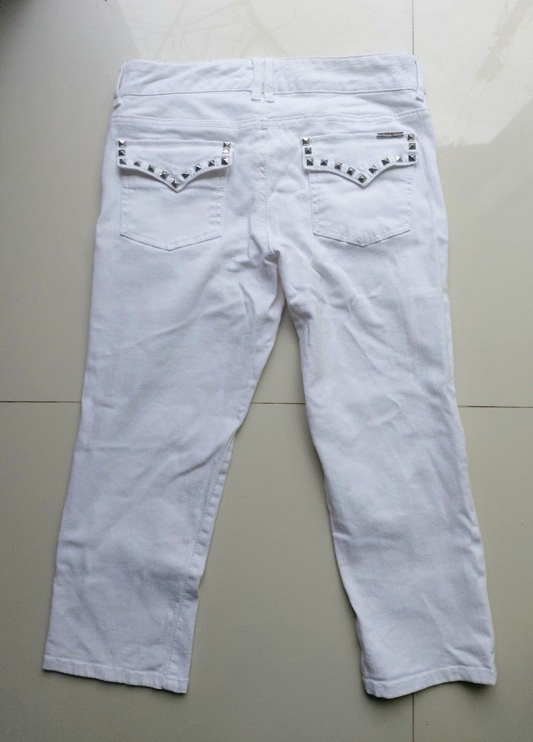 Michael Kors White Cropped Denim Jeans (Category: Jeans) located in Lapu Lapu. Submitted by agnesapm_29813 (Listing ID 1466282192, Image 3). Description: - Brand: Michael Kors - Color: Clean white wash - Fit: Mid-rise cut with standard belt loops - Closure: Unique double button waist - Details: Silver studded detailing on back pocket flaps - Measurements: waist-30 inches on tape measure, height-30 inches .