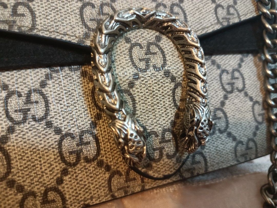 Gucci GG Mini Chain Crossbody Bag (Category: Cross-body Bags) located in Manila. Submitted by preloved439 (Listing ID 1466322880, Image 3). Description: - Gucci mini crossbody bag with classic GG monogram design - Features distinct silver-toned horseshoe closure with tiger head details - Chic black suede and structured side gussets - Includes a sturdy antique-finish metal chain strap - Compact size ideal for essentials and night outs.