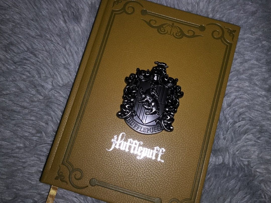 Miniso Harry Potter Hufflepuff A5 Hardcover Notebook (Category: Stationery & School Supplies) located in Paranaque City. Submitted by thriftsbyrei (Listing ID 1466335768, Image 1). Description: PRICE NEGOTIABLE!!! - Item: Miniso Harry Potter Hufflepuff Hardbound journal - Size: A5 - Details: PU embossed hardcover with metallic front crest - Condition: Brand new, still in original plastic packaging - Provenance: Bought from Miniso Parañaque City (