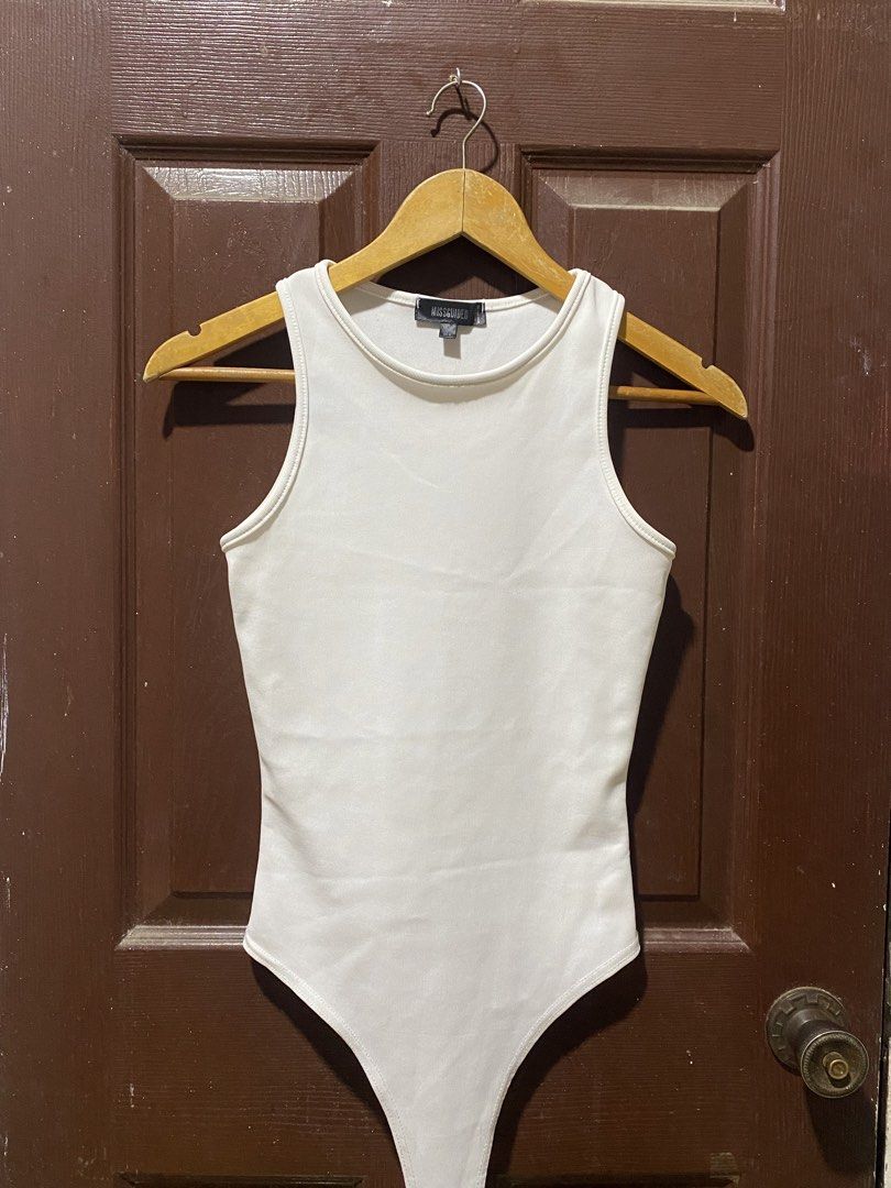 Missguided White Ribbed Bodysuit UK 10 (Category: Sleeveless) located in Calamba. Submitted by soleilcollections.ph (Listing ID 1466237342, Image 1). Description: - Brand: Missguided - Color: White - Style: Classic ribbed tank bodysuit, sleeveless - Size: UK 10 / EUR 38 / US 6 - Condition: Clean and well-maintained - Versatile basic piece, perfect for pairing with jeans or skirts.
