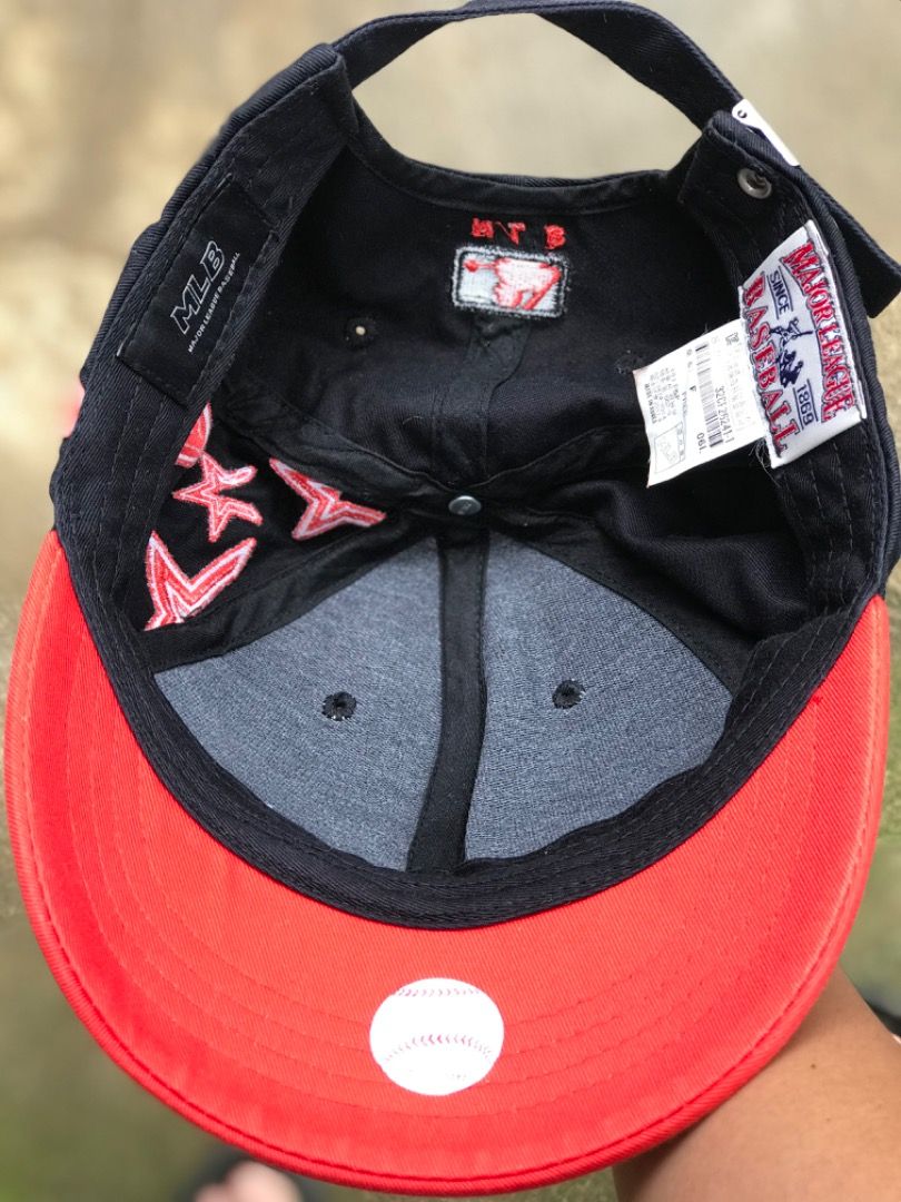 MLB Black And Red Star Baseball Cap (Category: Caps & Hats) located in Jimenez. Submitted by onlythrifty_ (Listing ID 1466210502, Image 3). Description: - Authentic MLB baseball cap in sleek black with vibrant red details - Features eye-catching red embroidered stars along the side and back panels - Bold bright red brim adds a standout pop of color - Adjustable strap closure at the back for a customizable, comfortable fit - Official MLB branding 