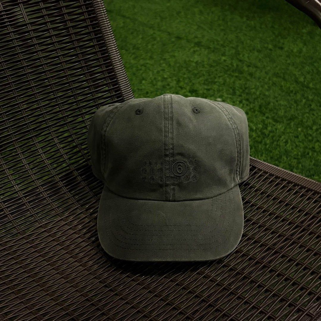 MM6 Maison Margiela Number Logo Baseball Cap (Category: Caps & Hats) located in Santa Rosa. Submitted by klarksantos (Listing ID 1466280112, Image 1). Description: - Brand/Model: MM6 Maison Margiela baseball cap - Color: Dark grey with a washed finish - Material: Sturdy canvas - Details: Subtle embroidered numeric logo on the front, interior numeric branding labels - Closure: Adjustable metal strap at the back - Condition: Barely worn, clean shap