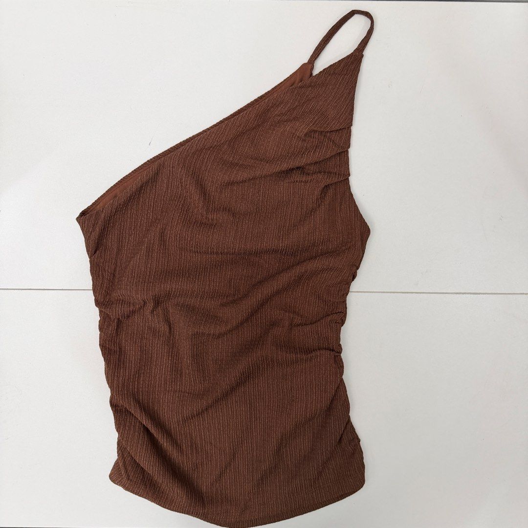 MNG Mango Brown One Shoulder Ruched Top Size XS (Category: Sleeveless) located in Pasig City. Submitted by boymom20 (Listing ID 1466197883, Image 2). Description: - Brand: MNG Mango - Condition: Brand new with tag (BNWT) - Size: EUR/USA XS, MEX ECH - Color: Brown - Material/Design: Textured fabric with side ruching and asymmetric strap - Origin: Made in Turkey - Style: Versatile piece, great for casual wear or nights out LAST PRICE POSTED + 75 SH
