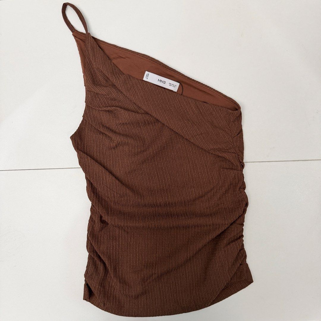 MNG Mango Brown One Shoulder Ruched Top Size XS (Category: Sleeveless) located in Pasig City. Submitted by boymom20 (Listing ID 1466197883, Image 1). Description: - Brand: MNG Mango - Condition: Brand new with tag (BNWT) - Size: EUR/USA XS, MEX ECH - Color: Brown - Material/Design: Textured fabric with side ruching and asymmetric strap - Origin: Made in Turkey - Style: Versatile piece, great for casual wear or nights out LAST PRICE POSTED + 75 SH