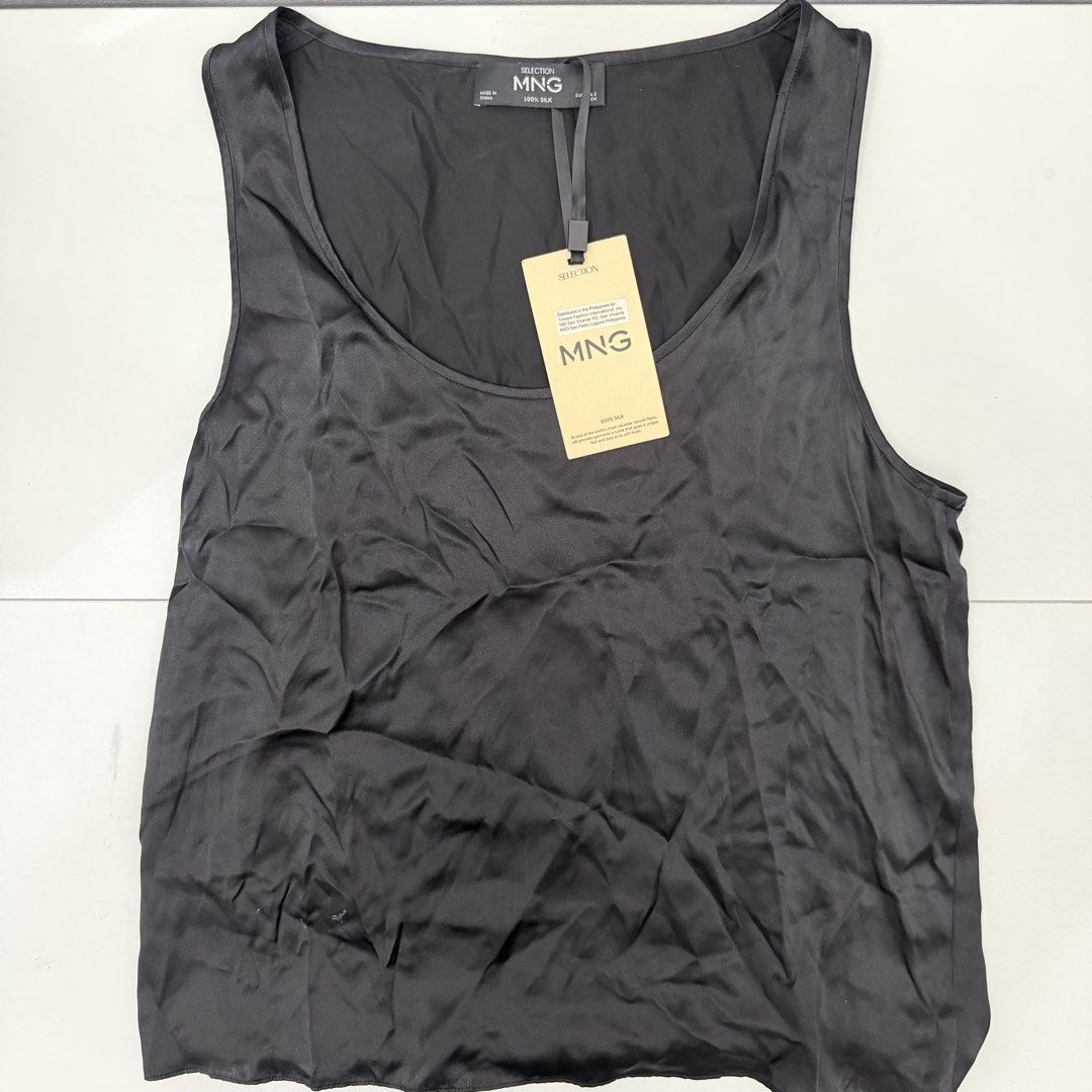 MNG Selection 100% Silk Black Tank Top (Category: Sleeveless) located in Pasig City. Submitted by boymom20 (Listing ID 1466197669, Image 1). Description: - Brand: MNG Selection - Material: 100% pure silk with a smooth finish - Color: Classic black - Details: Scoop neckline, lightweight, regular fit - Condition: Brand new with original retail tags attached, never worn - Style: Versatile piece, easy to dress up or down for day to night looks LAST P