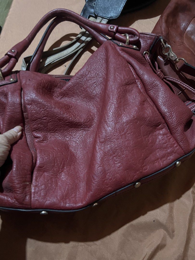 Morgan red leather shoulder bag (Category: Shoulder Bags) located in Makati City. Submitted by sinner_or_saint101 (Listing ID 1466335019, Image 1). Description: - Brand: Morgan - Material: Soft red leather with gold-tone hardware - Style: Slouchy shoulder bag with double top handles - Closure: Secure zip-top closure - Interior: Branded fabric lining with 1 zipped pocket and slip compartments - Extra: Metal feet on the bottom panel for protection.