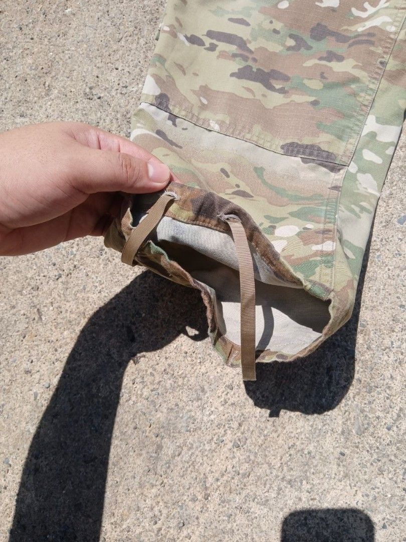 Multicam Camouflage Military Cargo Pants with Drawstring Cuffs (Category: Jeans) located in Mangaldan. Submitted by manuelingalla_3rd (Listing ID 1466296426, Image 3). Description: - Multicam camouflage pattern ideal for outdoor use and airsoft - Multiple side and back cargo pockets for convenient storage - Reinforced knees for enhanced durability in tough conditions - Adjustable drawstring leg openings designed to fit over boots - Sturdy cotton-