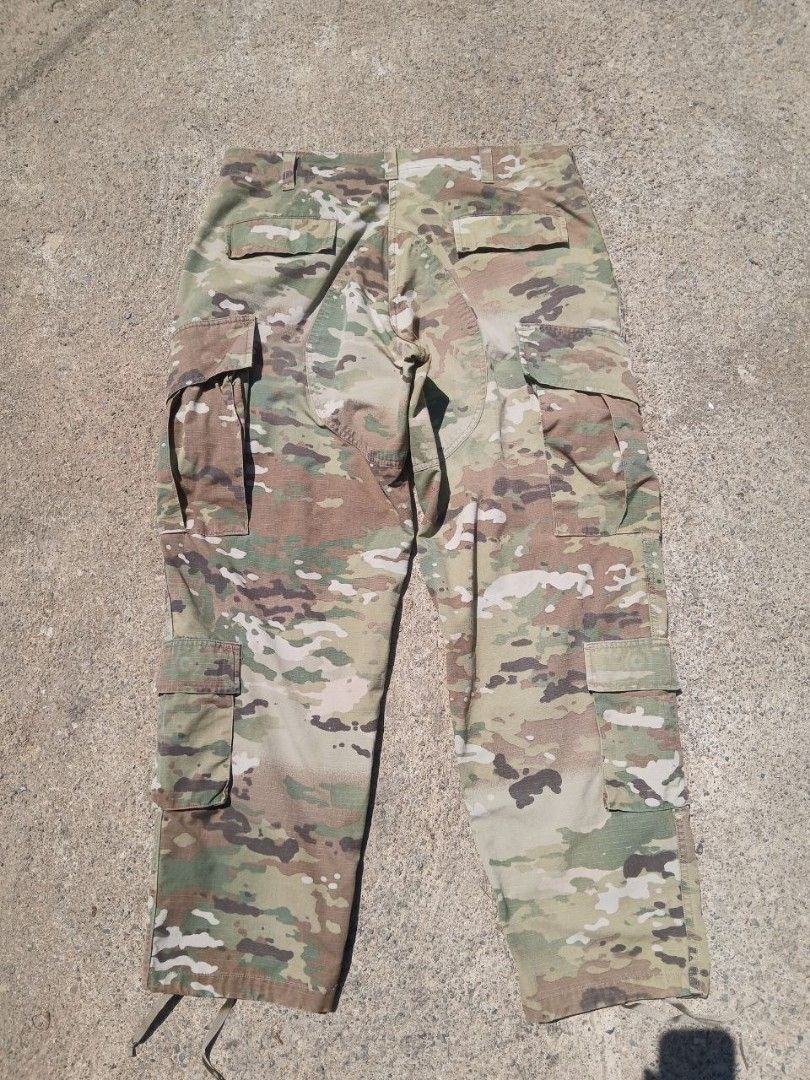 Multicam Camouflage Military Cargo Pants with Drawstring Cuffs (Category: Jeans) located in Mangaldan. Submitted by manuelingalla_3rd (Listing ID 1466296426, Image 2). Description: - Multicam camouflage pattern ideal for outdoor use and airsoft - Multiple side and back cargo pockets for convenient storage - Reinforced knees for enhanced durability in tough conditions - Adjustable drawstring leg openings designed to fit over boots - Sturdy cotton-