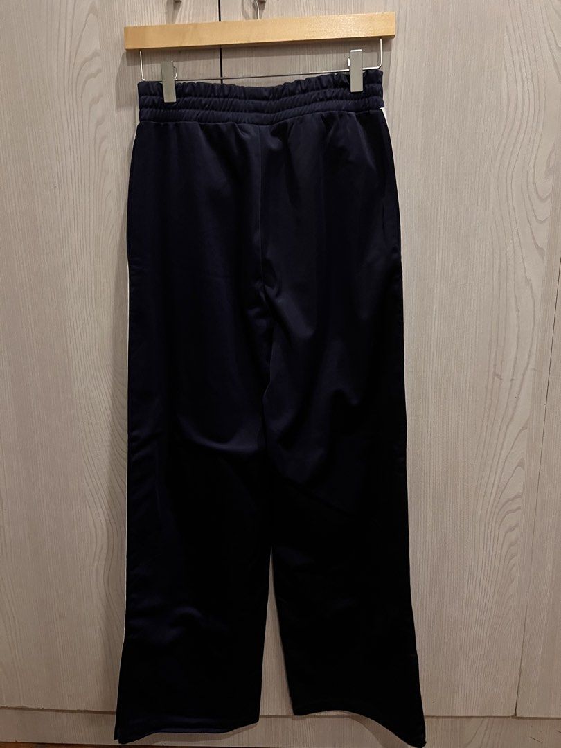 Navy blue wide leg jogging pants (Category: Other Bottoms) located in Makati City. Submitted by nwcloset (Listing ID 1466247042, Image 2). Description: Waist - 27 inches Length - 39 inches Zipper on both sides No flaws.