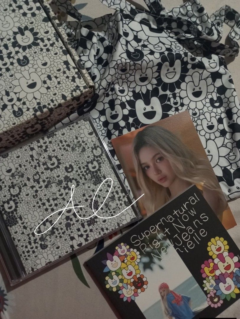 NewJeans Supernatural Danielle Ver. (Category: CDs & DVDs) located in Quezon City. Submitted by awhdri (Listing ID 1466254046, Image 1). Description: - NewJeans Supernatural Bag (Danielle Version) - Complete Inclusions except PCS •sealed CD in jewel case, photobook, Takashi Murakami flower print tote bag, and outer box - All items shown in pictures are included - Outer box have some dents - Qc Loc.