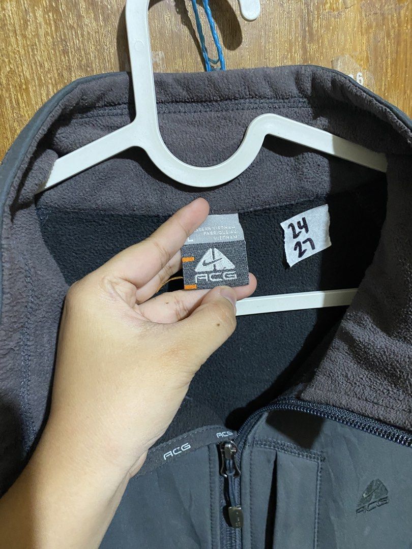 Nike ACG Grey Full Zip Jacket (Category: Coats, Jackets and Outerwear) located in Imus. Submitted by frootiloots4103 (Listing ID 1466208732, Image 3). Description: - Brand: Nike ACG - Style: Full zip jacket with stand-up collar - Color: Dark Grey - Size: Large 24x27 - Material: 100% polyester (Made in Vietnam) - Lining: Fleece lining inside the collar and body for extra warmth - Pockets: 1 vertical zipped chest pocket + 2 hand pockets - Details: 