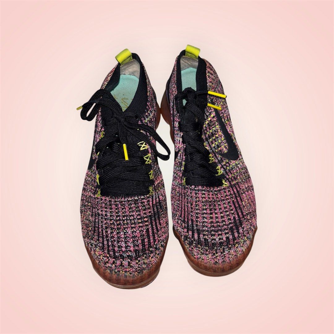Nike Air Vapormax Flyknit 3 (Category: Sneakers) located in Rosario. Submitted by preloveditems2002 (Listing ID 1466240574, Image 1). Description: - Brand: Nike Air Vapormax Flyknit - Colorway: Multicolor (Pink, Black, Yellow accents with a Black Swoosh) - Sole: Translucent gradient Air sole units for maximum cushioning - Details: Neon yellow pull tabs, turquoise heel strip branding, and black laces with yellow aglets - Fit: Snug, sock-like ankle